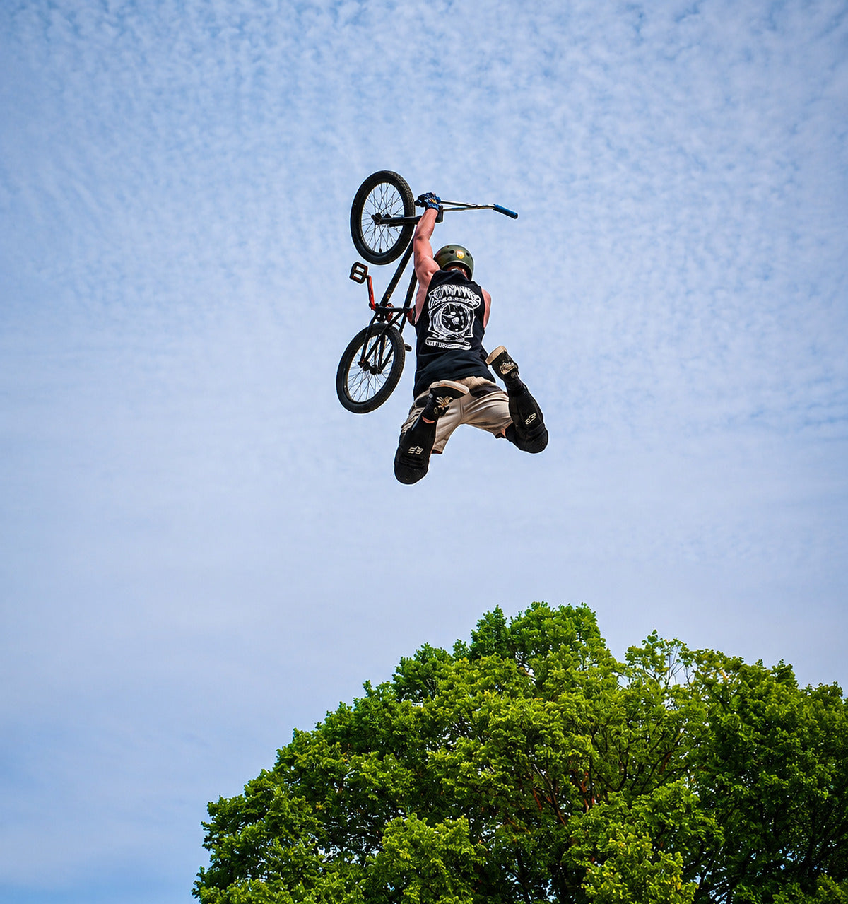 BMX rider in motion on a dirt track, mobile hero
